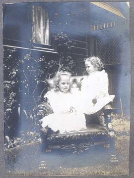 two girls on a leather chair, outdoors