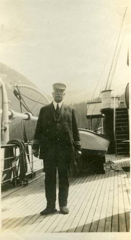 Uniformed man on a ship deck