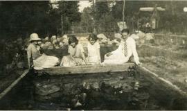 Four people looking into a pool