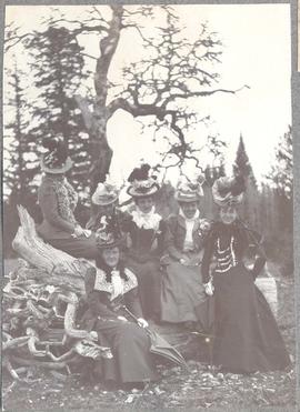 Byrdie Dunsmuir and her aunts on a tree stump