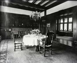 Dining room set with a small table in centre of room.