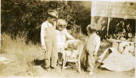 three young children with seated teddies