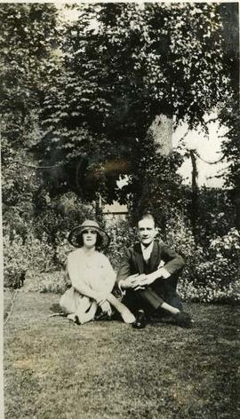 Eileen Molyneux and Clifton Webb seated in a garden