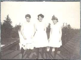 Three girls in petticoats on Burleith roof