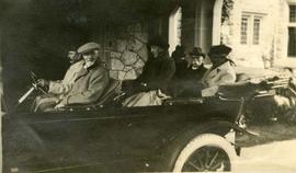 James Dunsmuir and friends in vehicle under porte cochere, Hatley Park