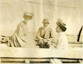 two women and a man on a boat