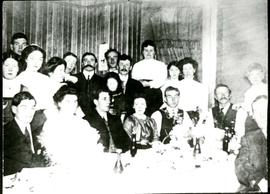 Photo of a group of 20 people gathered around a table