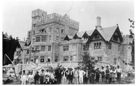 Hatley castle from south east with construction crew in front.