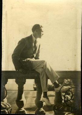 Man sitting on stone balustrade