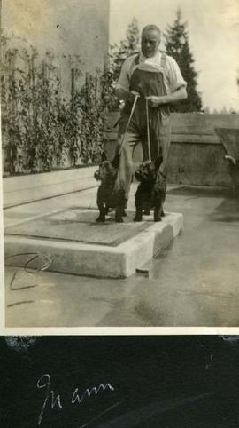 WEJ (Fred) Mann in overalls with two dogs