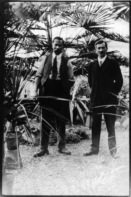 Philip Francis Hayward (right) and helper inside the greenhouse