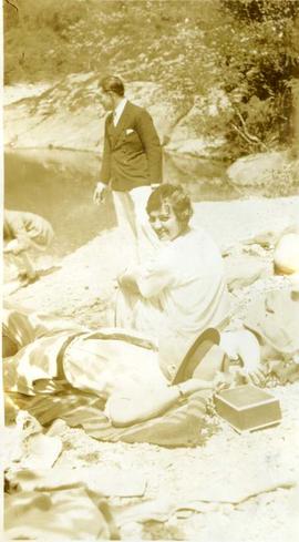 two couples sunning on a riverbank