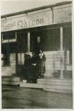 women in front of a saloon