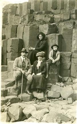 Guy and James Audain and two women sat on basalt rock formations