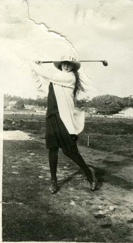 Long haired girl golfing