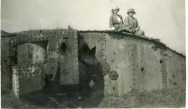 Muriel and Dola sat on top of a destroyed British tank, exact mark unknown