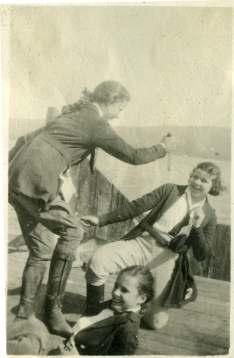 Three women playing, Dola on right