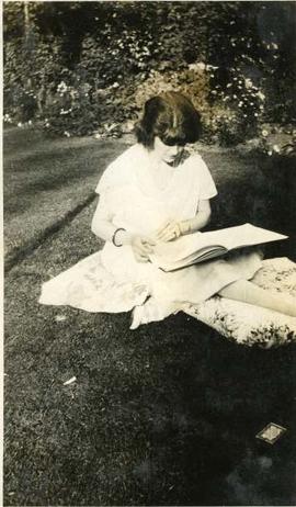 woman reading on a lawn