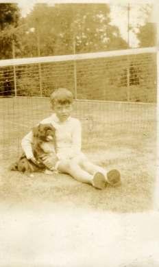 James Humphreys and a dog on the tennis court lawn, Hatley Park